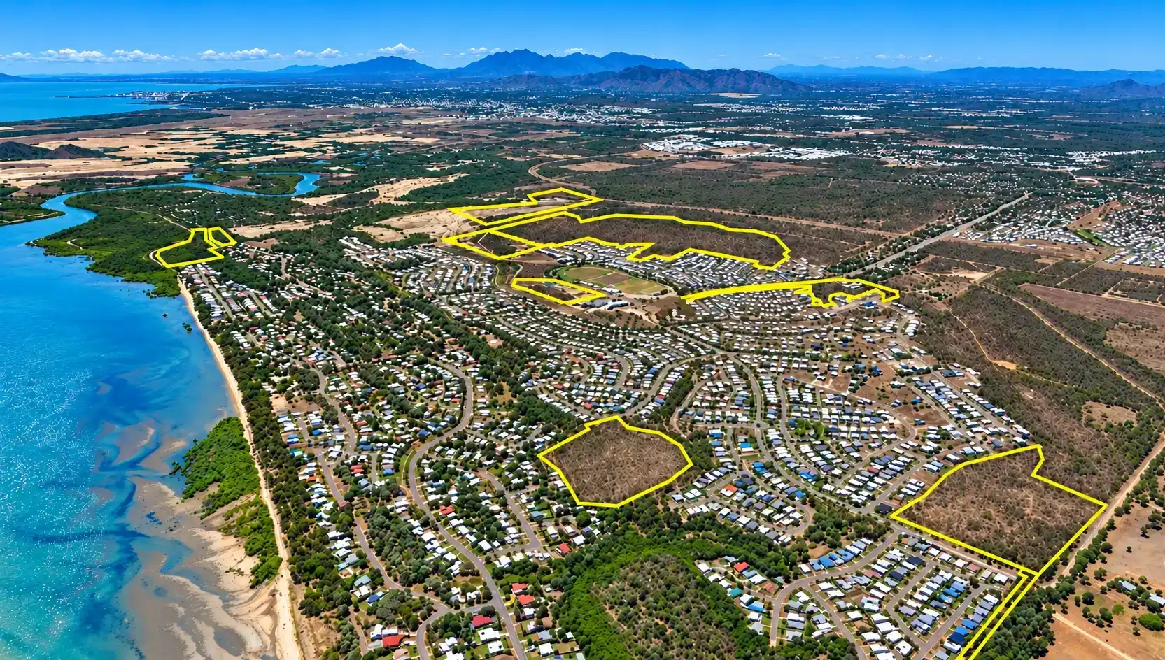 Aerial view of a coastal community near Townsville with land parcels outlined